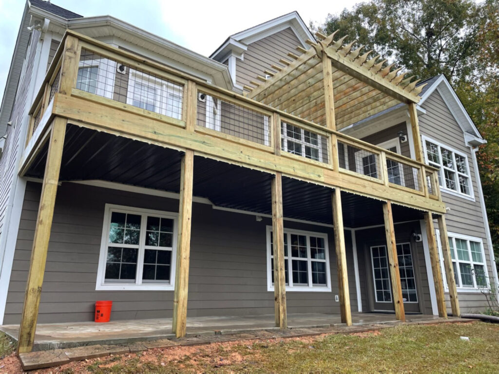 porch builder and sunroom addition contractors Dennis Home Improvement complete a back porch addition with a deck pergola