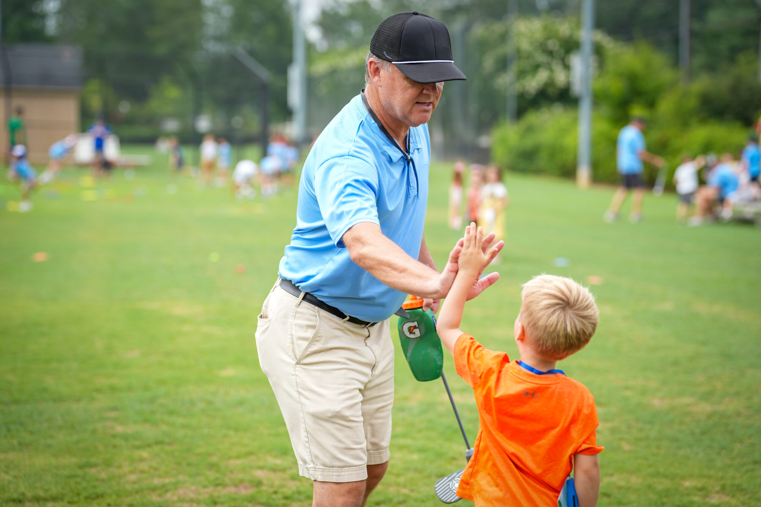 Young golfer practicing putting at a G1 Golf station